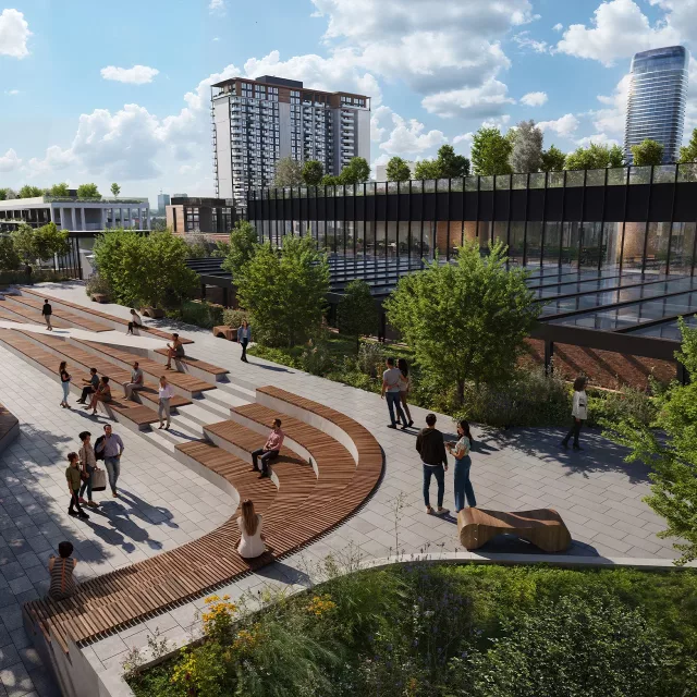 People walk and rest in the landscaped area around the market at Belgrade Waterfront