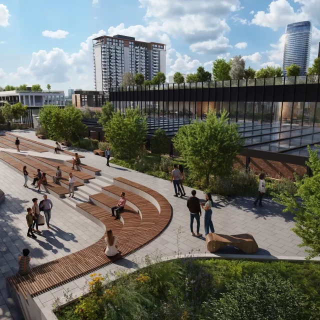 People are enjoying sitting in front of the new, green, covered market in Belgrade Waterfront.
