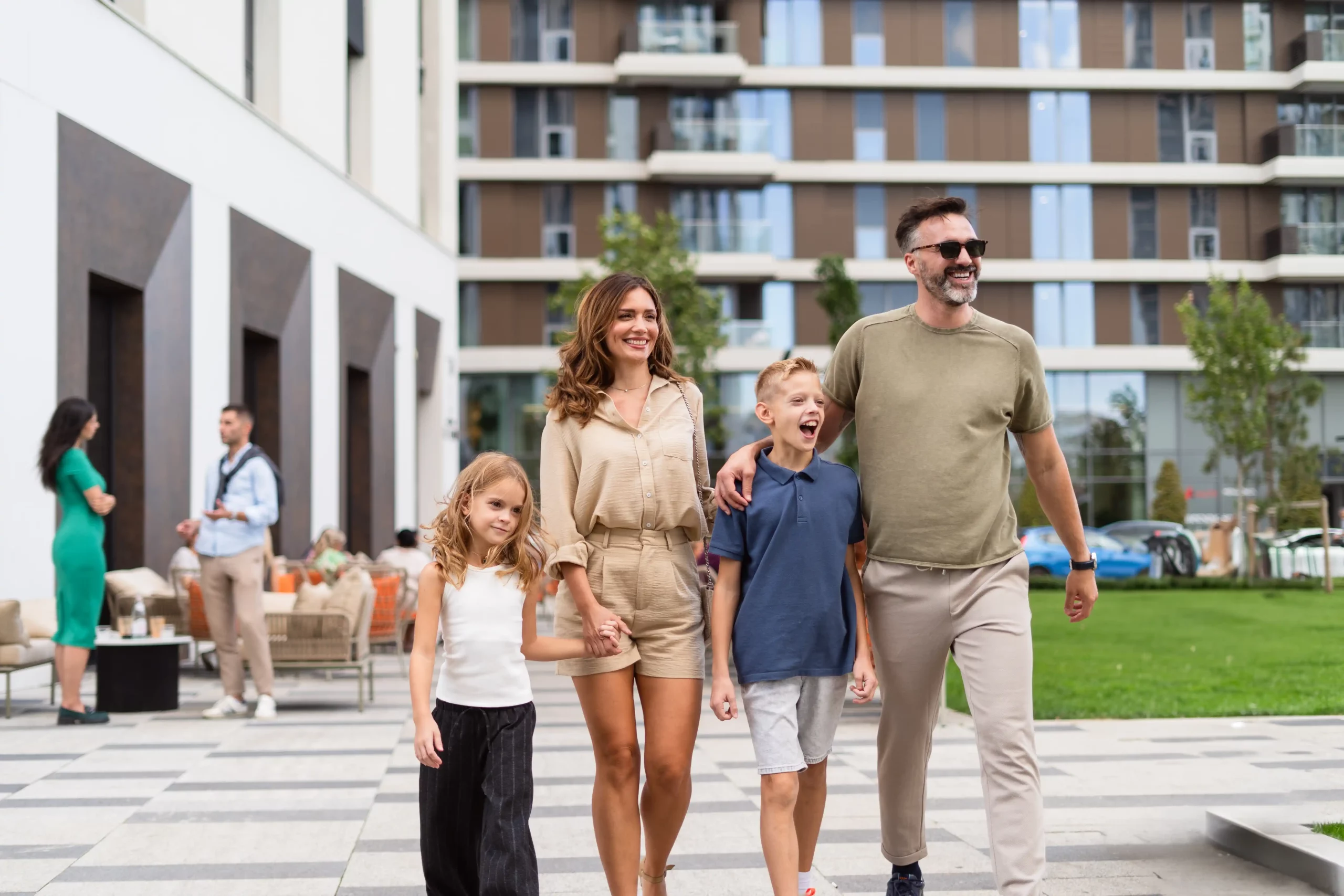 A family from Belgrade Waterfront enjoys a peaceful stroll through the park, admiring the natural beauty and lush greenery.