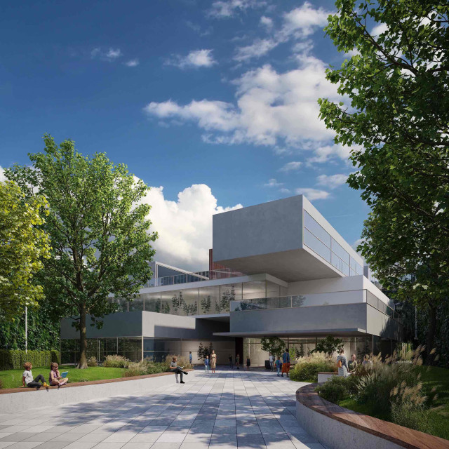 A spacious walkway to the bilingual primary school with benches and greenery.