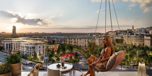 A resident of Belgrade Waterfront enjoying the sunset view from the apartment terrace in the BW Oda building.